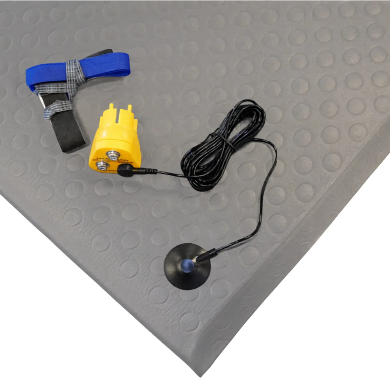 M4 ESD floor mat kit contents laid on the grey mat: heel grounder, earth bonding plug and grounding lead. Accessories ship with the Kit sizes only